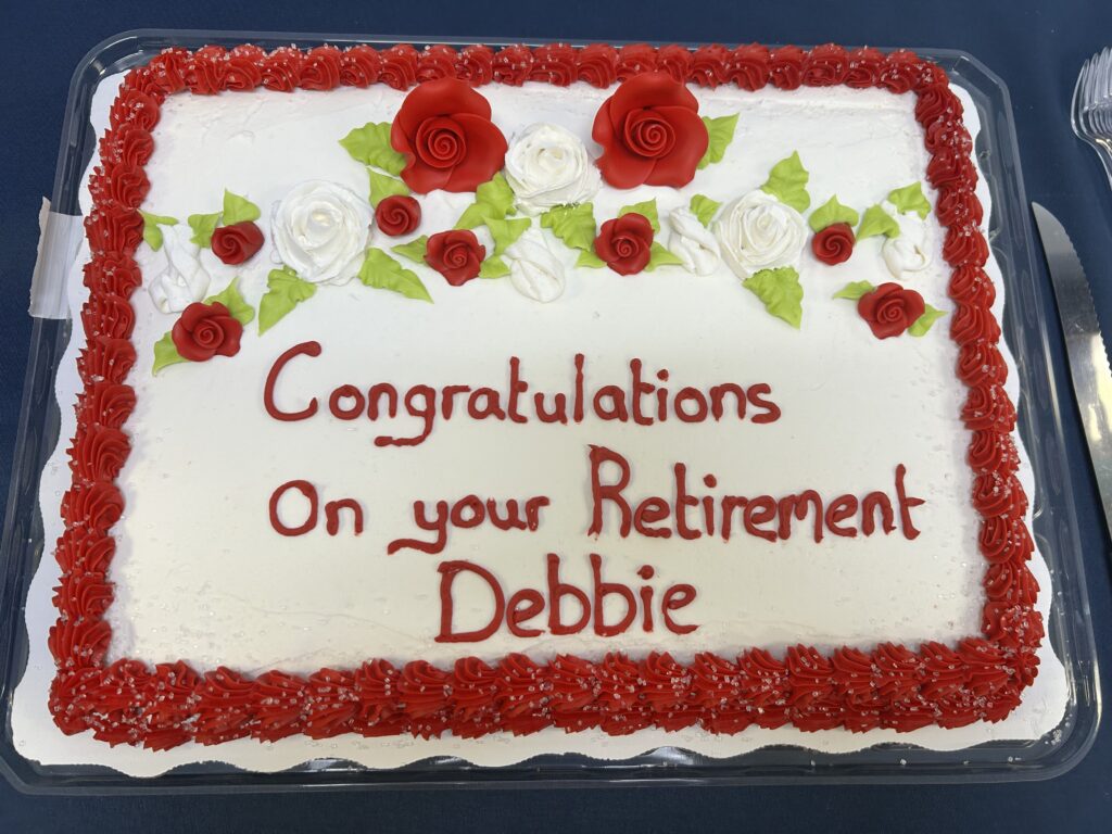 Congratulations on your retirement Debbie written on cake