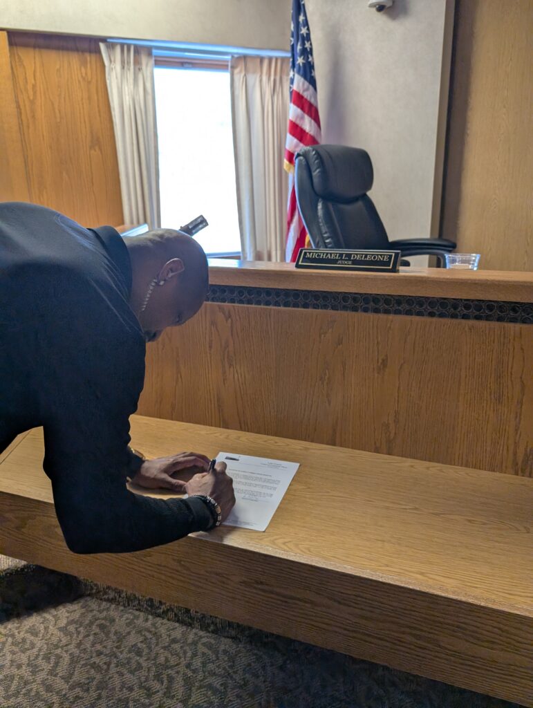 Judge DeLeone swearing in Ken Swindler as a Juvenile Corrections Officer.