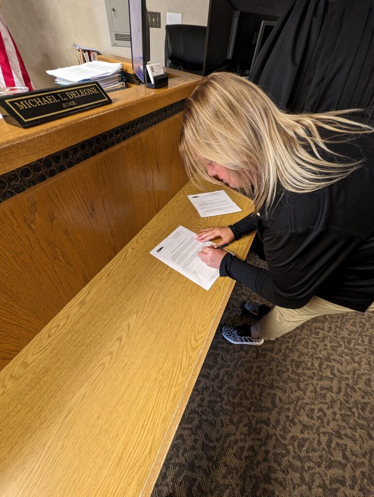Judge DeLeone swearing in Sadie Mollard as a Juvenile Corrections Officer