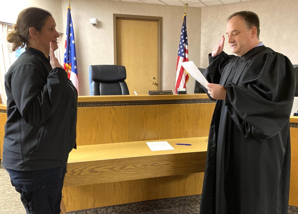 Judge DeLeone swearing in Clerk from WIllowick Police Department
