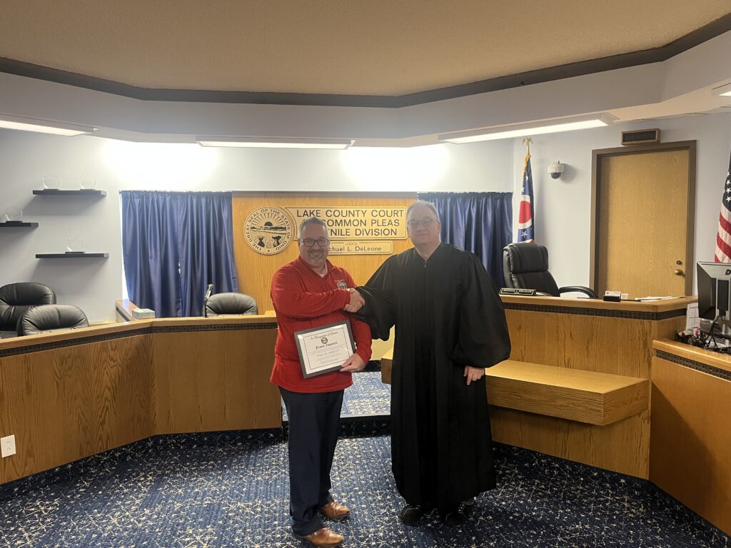 Frank Zupancic and Judge DeLeone standing in a courtroom